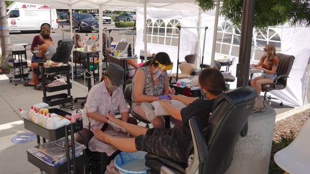 A nail salon has moved its operations outside during Covid-19 pandemic. stock photo