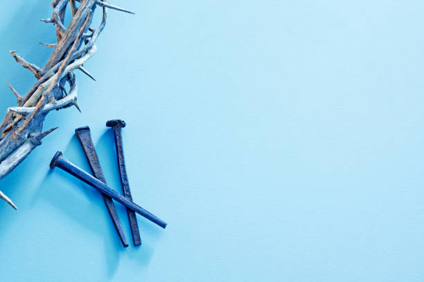 Crown of thorns and nails on a blue background.