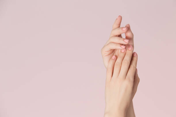 Nails care and beauty theme Woman hands with clean skin and nails with pink polish manicure on pink background. Nails care and beauty theme. Beauty background with copy space. fingernail stock pictures, royalty-free photos & images