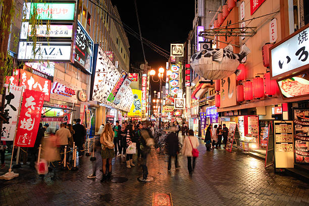 Namba entertainment district, Osaka, Japan "Osaka, Japan - March 18, 2012: Namba entertainment district. Many people can be seen in the pedestrian zone outside shops and restaurants." mcdonalds japan stock pictures, royalty-free photos & images