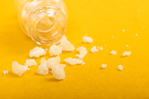 narcotic salt crystals amphetamine on yellow background narcotic salt crystals amphetamine on yellow background. mephedrone stock pictures, royalty-free photos & images