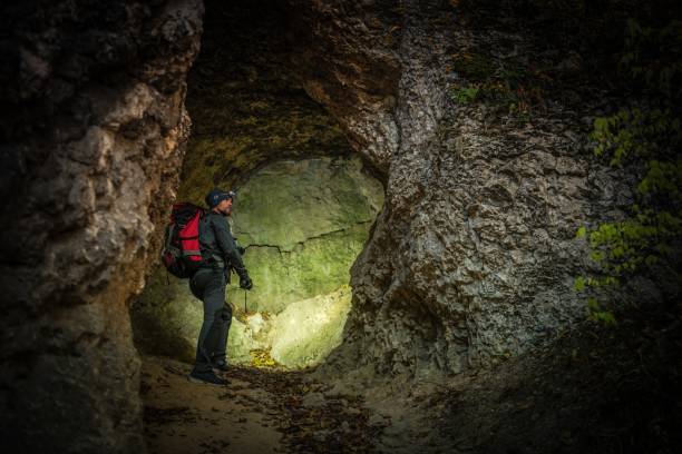 narrow cave expedition - höhlenklettern stock-fotos und bilder
