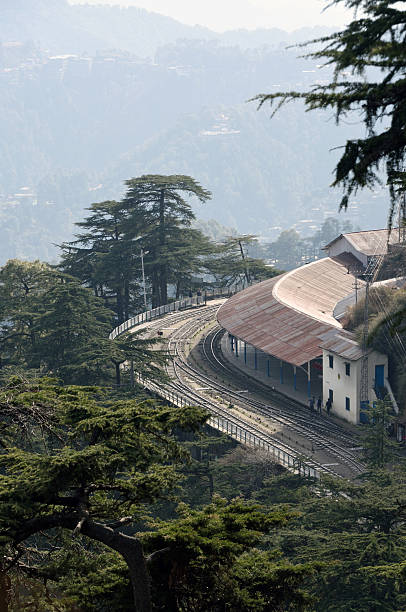 Narrow Gauge Railway Station at Shimla Railway in India Looking down on Shimla Station, the northern terminus of the Kalka Shimla Railway in northern-western India. This line, built to 2 ft 6 in (762 mm) narrow gauge, runs for 96 kilometers from Kalka, on the broad gauge line from Delhi, to Shimla in the south-western Himalayan ranges. shimla stock pictures, royalty-free photos & images