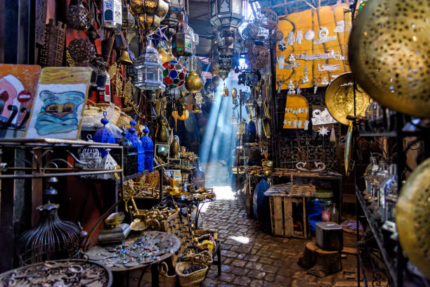 Narrow passage in the Marrakesh souq, Morocco Marrakesh, Morocco - December 30, 2017: A Narrow passage in the Souk Haddadine. A souq or souk is a marketplace or commercial quarter in Western Asian, North African and some Horn African cities souk stock pictures, royalty-free photos & images