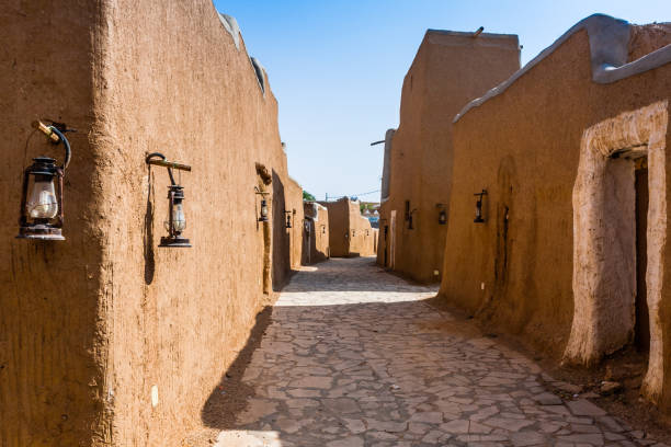 A narrow street in a traditional Arab mud brick village, Al Majmaah, Saudi Arabia The restored streets in the Munikh Castle suburbs old house arabic stock pictures, royalty-free photos & images