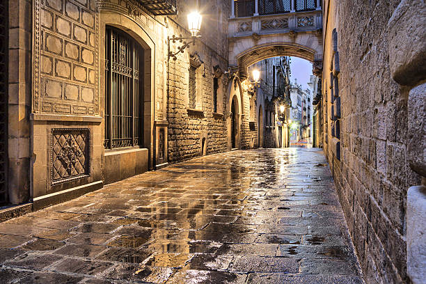 Narrow street in gothic quarter, Barcelona Narrow street Carrer del Bisbe in gothic quarter, Barcelona, Spain bbsferrari stock pictures, royalty-free photos & images