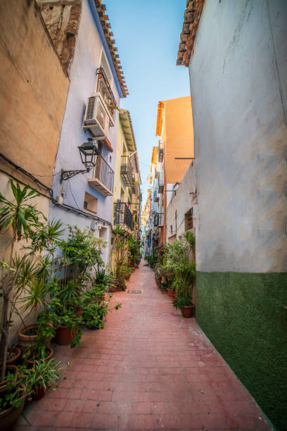 Narrow street in the historic center of the town of Villajoyosa, Alicante, Spain. stock photo