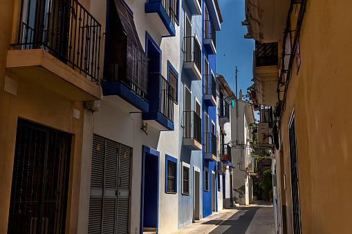 Narrow street in the historic center of the town of Villajoyosa, june 2021, Villajoyosa, Alicante, Spain.