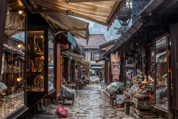 Narrow street of the Bascarsija district of Sarajevo, with typical metal copper crafts being produced with ottoman techniques. Bascarsija is the symbol of Sarajevo, with its oriental architecture Picture of one of Bascarsija's streets. Bascarsija is Sarajevo's old bazaar and the historical and cultural center of the city. It was built in the 15th century during the foundation of the city bosnia and hercegovina stock pictures, royalty-free photos & images
