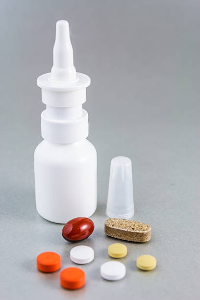 Nasal spray and various pills stock photo