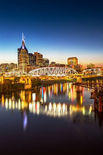 Nashville Skyline and John Seigenthaler Pedestrian Bridge at Dusk stock photo