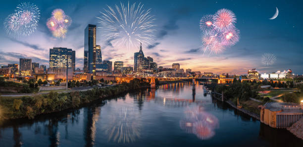 Nashville skyline during blue hour with river front and fireworks stock photo