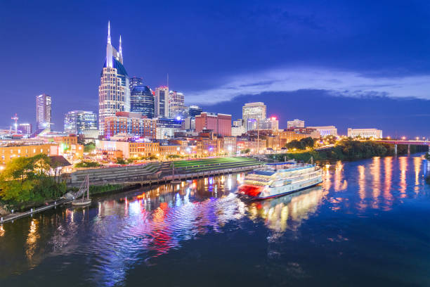 Nashville, Tennessee, USA Nashville, Tennessee, USA skyline and riverboat on the Cumberland River at night. cumberland river stock pictures, royalty-free photos & images