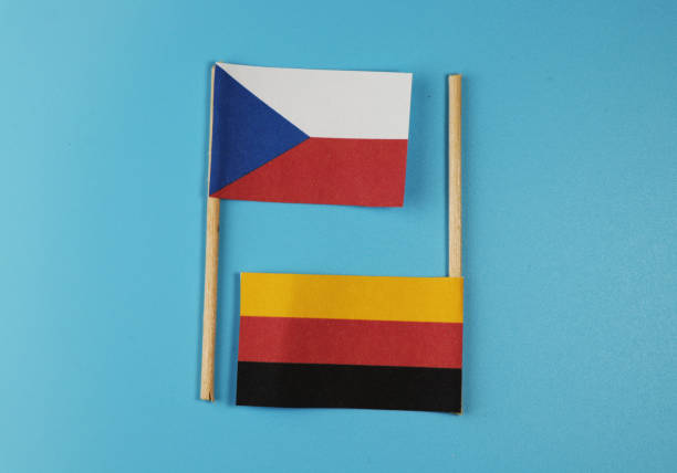 A national czech flag with flag of germany on wooden sticks. stock photo