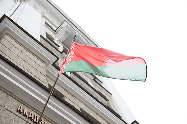National Flag of Belarus National flag of Republic of Belarus waving from an administrative building on a breezy morning. Belarus is a Republican country and is one of the most properous nations across Europe.  minsk stock pictures, royalty-free photos & images