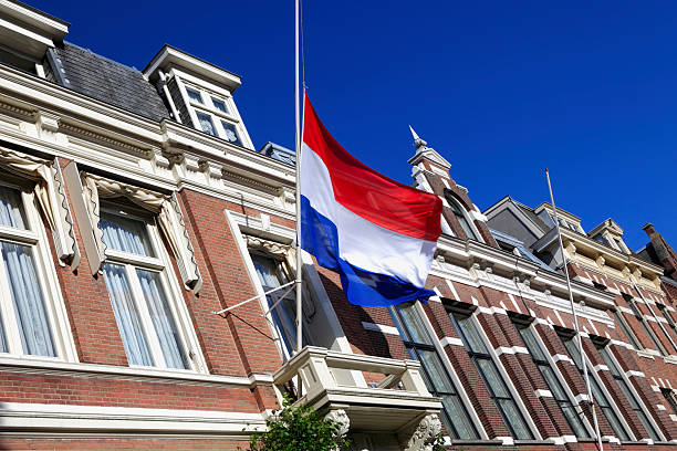 national flag of the Netherlands at half-mast Dutch flag at half-mast as a symbol of respect or mourning flag at half staff stock pictures, royalty-free photos & images