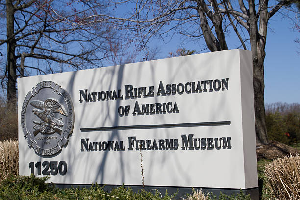 National Rifle Association Headquarters Sign Fairfax, Virginia, USA - April 05, 2013:  This sign is located in front of the NRA headquarters building and shows the seal of the National Rifle Association. The headquarters of the National Rifle Association is located in the suburbs of Virginia near Washington, DC.  The headquarters complex includes the National Firearms Museum as well as an indoor shooting range open to the public. nra stock pictures, royalty-free photos & images