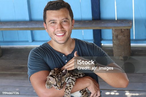 istock Native American man holding a baby wild feline 1194667726