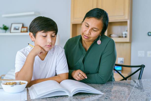 Native American mom helping son with homework stock photo