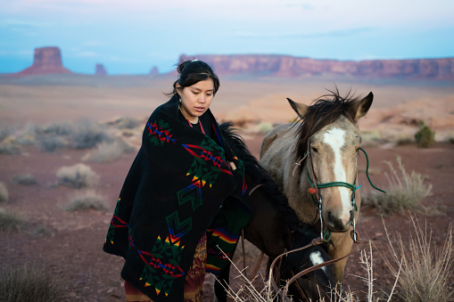 Native american woman with her beloved horse at the Arizona desert