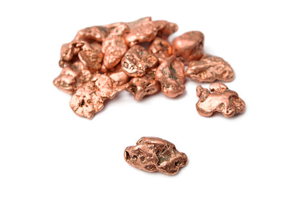Native Copper Copper nuggets - in a heap and one aside, isolated on white. copper stock pictures, royalty-free photos & images