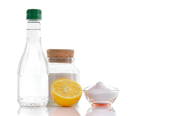 Natural cleaners. Vinegar, baking soda, salt and lemon. stock photo