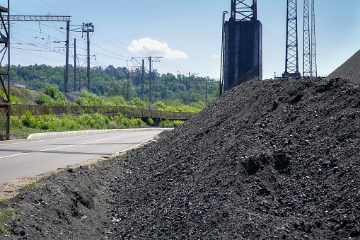 Natural heaps of industrial coal. Coal mine. Production of useful minerals.