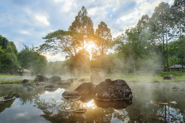 Natural hot spring mineral water with steam in Chae Son National Park in the morning, Lampang, Thailand. stock photo