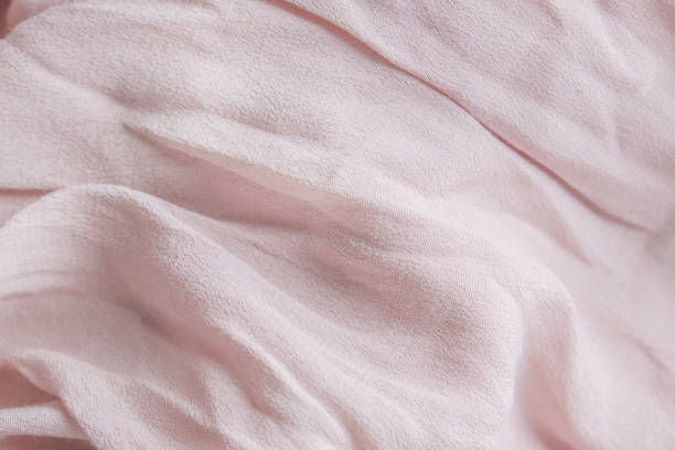 Natural nude gentle pink, light pastel textile cloth background, crumpled wavy texture stock photo