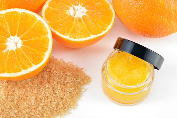 Natural orange sugar lip scrub on white. stock photo