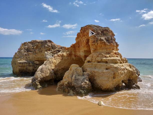 Natural rock in Albufeira water's edge. stock photo