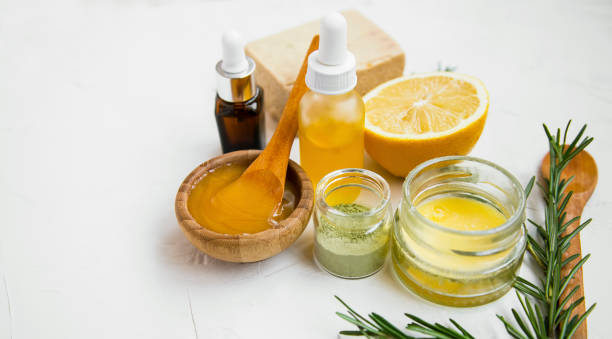 Natural skincare ingredients with manuka honey, lemon, essential oil, clay, balm, rosemary herbs and natural soap, healthy wellness and spa products stock photo