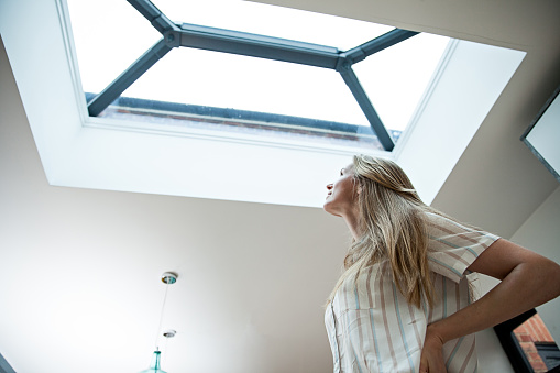 Woman looking into the skylight