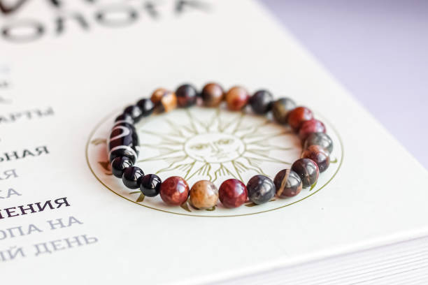 natural stone beads on the paper surface with astrological symbols is a bracelet made of natural stone beads semi precious gem stock pictures, royalty-free photos & images