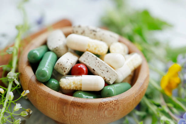 Natural suplements pills, alternative medicine with herbal plants extracts pills, herbal medicine, homeopathy organic super food suplements stock photo