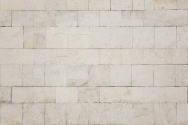 Natural texture and background. Marble tiled wall Natural texture and background. The wall of the house is covered with white marble tiles. megalith stock pictures, royalty-free photos & images