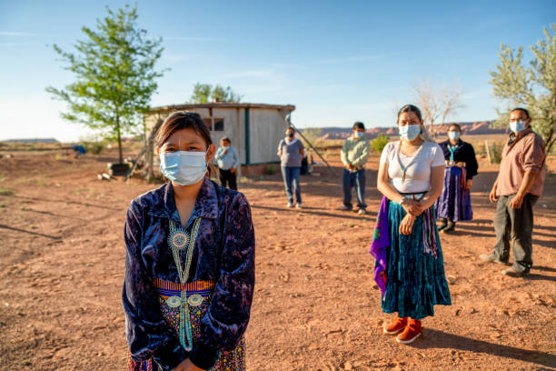 A Navajo Family Practicing Social Distancing, Wearing Masks During The Coronavirus Pandemic American indigenous family aware of the dangers of the Covid19 pandemic stands 6 feet apart from one another navajo nation covid stock pictures, royalty-free photos & images