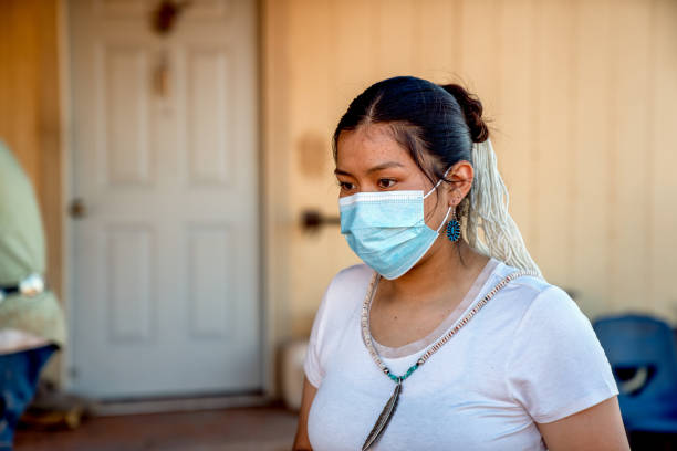 A Navajo Teenage Girl Wearing A Mask Protecting Her From Covid19, At Her home On Th Reservation A teenage Navajo girl wears a mask for protection from Coronavirus at her family property in Monument Valley Tribal Park navajo nation covid stock pictures, royalty-free photos & images