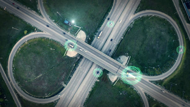 GPS navigation and autonomous driverless transportation concept. Aerial view of transport junction with cars and trucks driving with digital green circles, future global technology on roads GPS navigation and autonomous driverless transportation concept. Aerial view of transport junction with cars and trucks driving with digital green circles, future global technology on roads. surveillance stock pictures, royalty-free photos & images