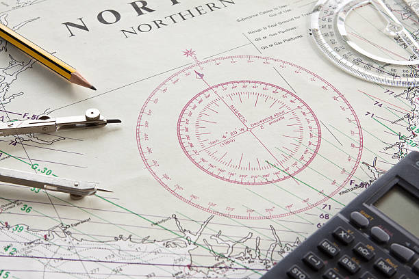 A navigation charting map with compass and a calculator stock photo