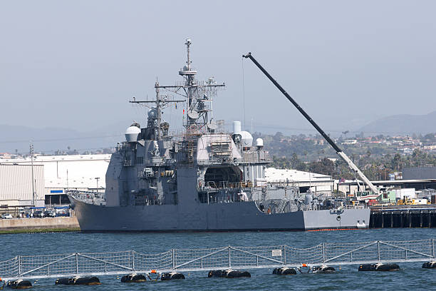US Navy Cruiser A US Navy Cruiser under maintenance in San Diego Harbour destroyer stock pictures, royalty-free photos & images