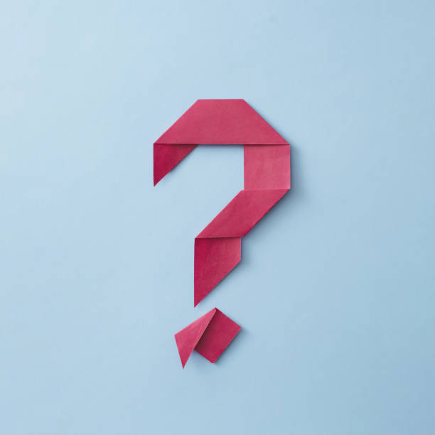 Neatly folded origami red paper question mark stock photo