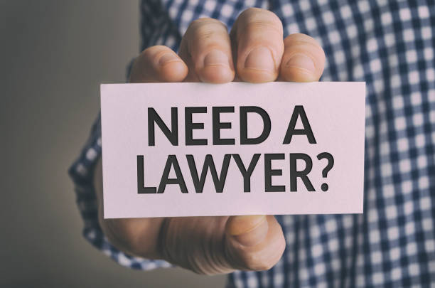 Need a lawyer? Need a lawyer? card in hand. Legal support and justice concept. need a lawyer stock pictures, royalty-free photos & images