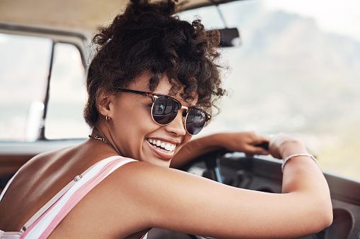 Cropped shot of a beautiful young woman enjoying herself while out on a road trip