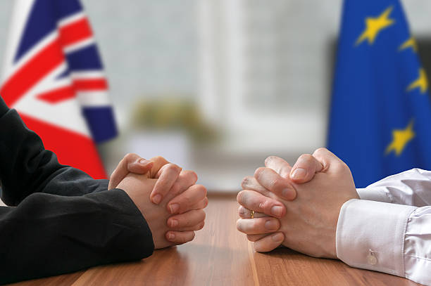 Negotiation - Great Britain and European Union (Brexit). Statesman, politicians. Negotiation of Great Britain and European Union (Brexit). Statesman or politicians with clasped hands. brexit stock pictures, royalty-free photos & images