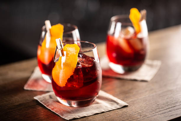 Negroni classic cocktail and gin short drink with sweet vermouth, red bitter liqueur and dried orange garnish. Negroni classic cocktail and gin short drink with sweet vermouth, red bitter liqueur and dried orange garnish. vermouth stock pictures, royalty-free photos & images