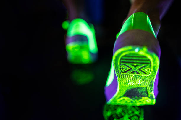 Neon glowing running shoes Neon glowing running shoes closeup. paint neon color neon light ultraviolet light stock pictures, royalty-free photos & images