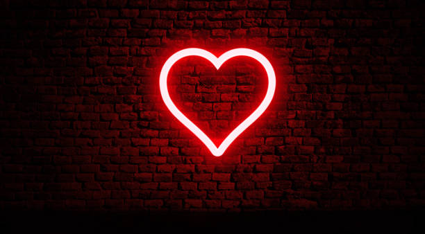 neon hart op bakstenen muur - romantiek begrippen stockfoto's en -beelden