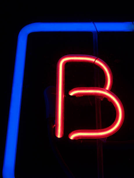 Neon Letter B; Retro Red and Blue Sign at Night stock photo