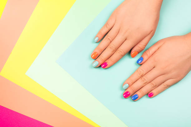 Neon manicure on multicolored bright background in trendy colors. Neon manicure on multicolored bright background in trendy colors. Flat lay style. nail polish stock pictures, royalty-free photos & images